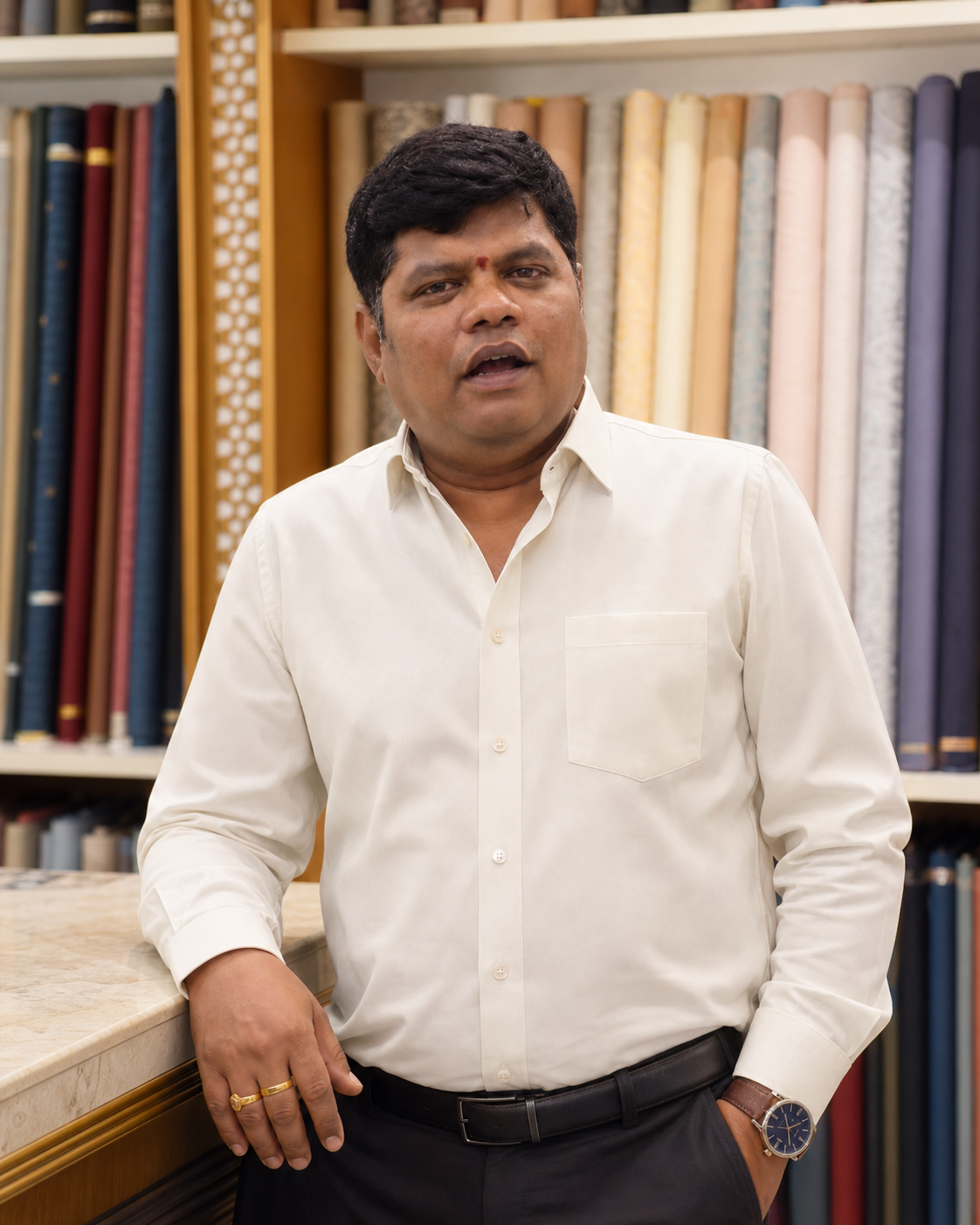 Ashok Gorla, founder of Deva Selections, standing at the fabric counter